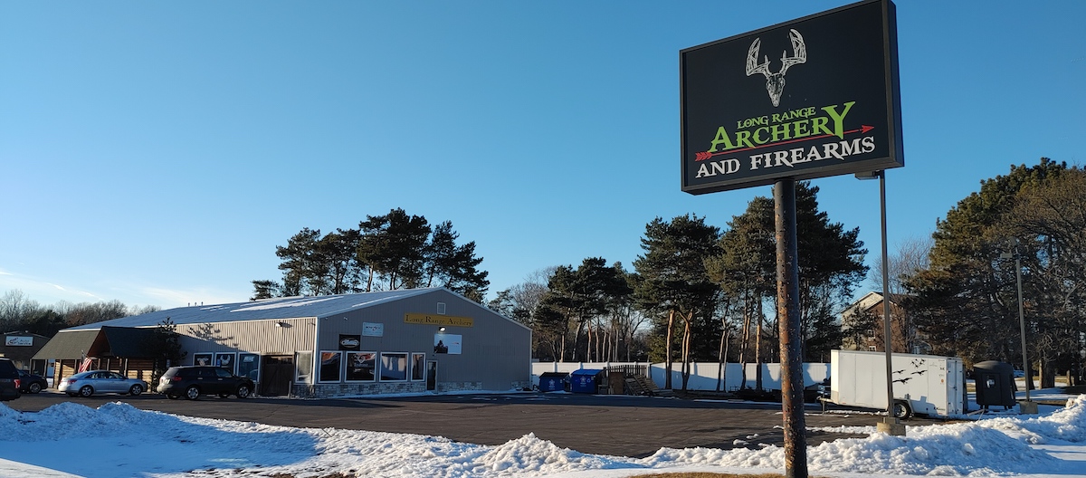 Exterior of Store with road sign Long Range Archery and Firearms